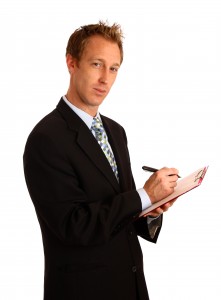 stockvault-a-young-businessman-holding-a-clipboard-160698